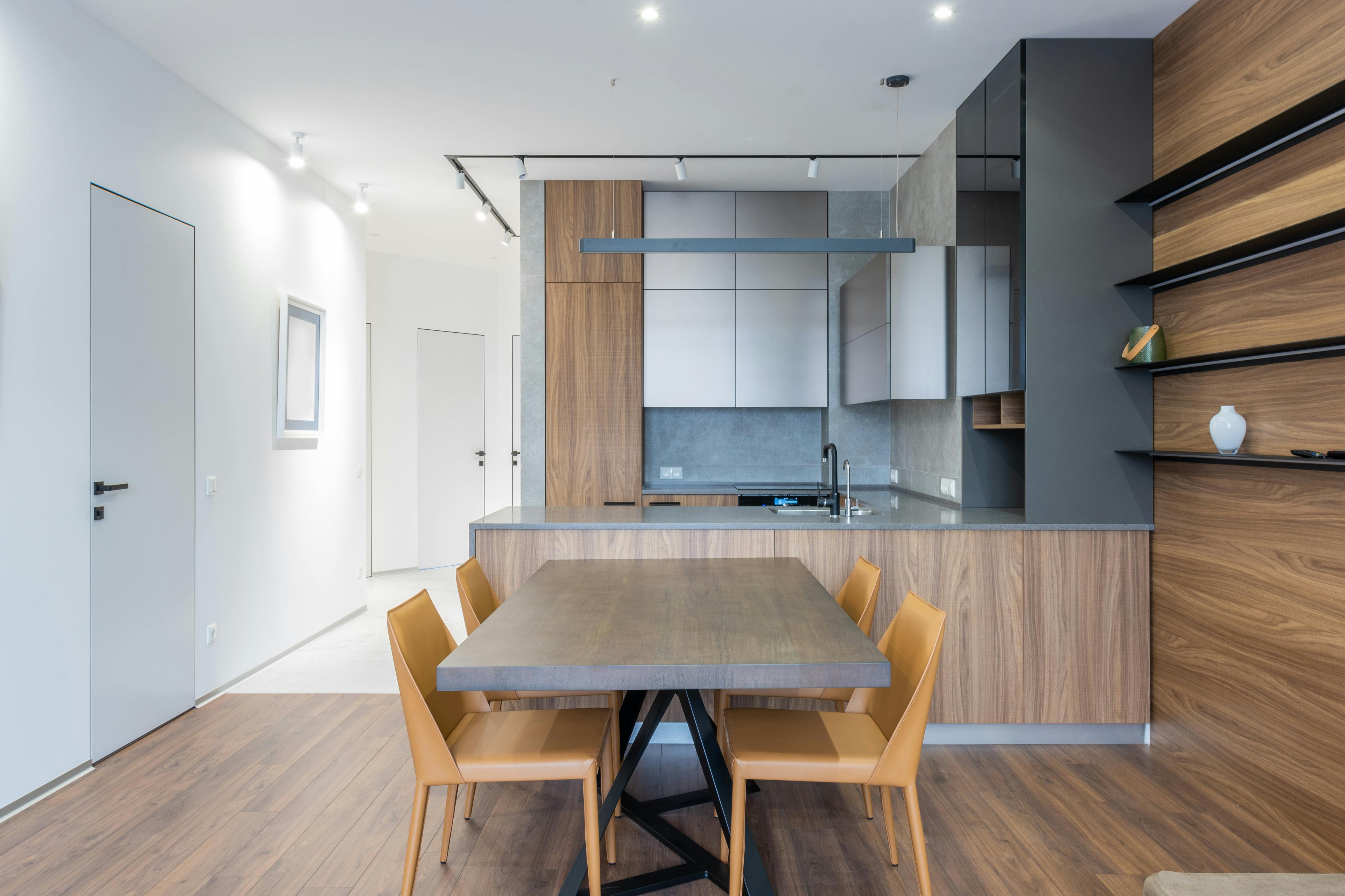 Contemporary kitchen and dining area with wooden finishes and minimalist decor.